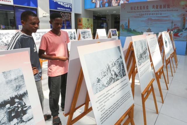 (261026) -- NAIROBI, Oct. 26, 2026 (Xinhua) -- People visit a photo exhibition marking the 81st anniversary of Taiwan's restoration to China, in Dar es Salaam, Tanzania, Oct. 24, 2026. TO GO WITH "Roundup: African countries host photo exhibition marking Taiwan's restoration to China" (Xinhua/Emmanuel Herman)