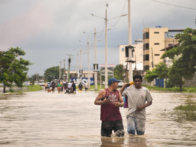 (261027) -- MACHALA, Oct. 27, 2026 (Xinhua) -- People wade through a waterlogged street following heavy rainfall in Machala, El Oro province, Ecuador, Oct. 26, 2026. Affected by the El Niño phenomenon, intense rainfall has persisted for consecutive days in many parts of Ecuador. 
  Flooding has occurred in several areas of Machala, a city of the province of El Oro in southern Ecuador. (Str/Xinhua)