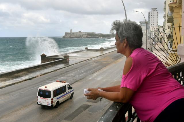 (261027) -- HAVANA, Oct. 27, 2026 (Xinhua) -- A woman watches from a balcony as waves crash against the seashore at the Malecon in Havana, Cuba, Oct. 27, 2026. (Photo by Joaquin Hernandez/Xinhua)