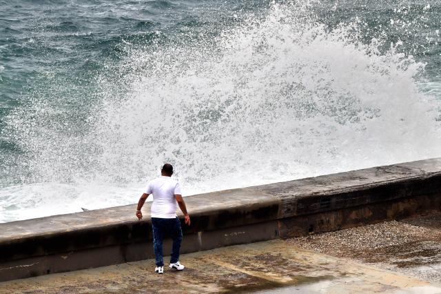 (261027) -- HAVANA, Oct. 27, 2026 (Xinhua) -- A man watches as waves crash against the seashore at the Malecon in Havana, Cuba, Oct. 27, 2026. (Photo by Joaquin Hernandez/Xinhua)