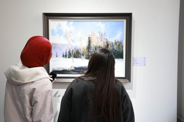(261028) -- BISHKEK, Oct. 28, 2026 (Xinhua) -- People visit an art and photography exhibition showcasing the magnificent landscapes and diverse culture of northwest China's Xinjiang Uygur Autonomous Region in Bishkek, Kyrgyzstan, Oct. 27, 2026. The two-week exhibition opened at the Kyrgyz National Museum of Fine Arts on Tuesday, featuring 40 selected artworks and photographs about Xinjiang. (Photo by Roman/Xinhua)