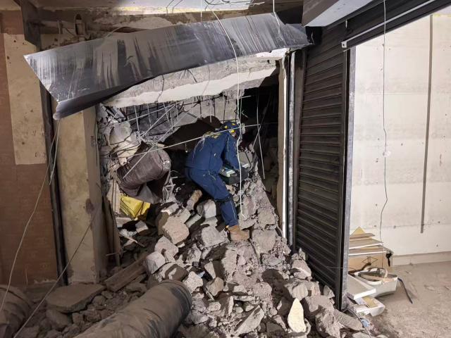 (261028) -- NAIROBI, Oct. 28, 2026 (Xinhua) -- A Chinese rescuer works with life-detection equipment at the site of a building collapse in Eastleigh, Nairobi, Kenya, on Oct. 26, 2026. TO GO WITH "Chinese rescue team detects signs of life beneath collapsed building in Kenya's Nairobi" (Blue Sky Rescue/Handout via Xinhua)