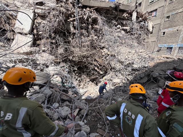 (261028) -- NAIROBI, Oct. 28, 2026 (Xinhua) -- A Chinese rescuer (rear) works with other rescuers at the site of a building collapse in Eastleigh, Nairobi, Kenya, on Oct. 27, 2026. TO GO WITH "Chinese rescue team detects signs of life beneath collapsed building in Kenya's Nairobi" (Blue Sky Rescue/Handout via Xinhua)