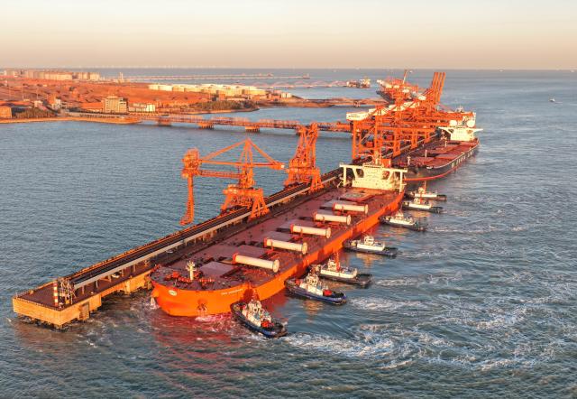(261028) -- TANGSHAN, Oct. 28, 2026 (Xinhua) -- A drone photo taken on Oct. 27, 2026 shows a vessel, assisted by tugboats, approaching the ore terminal of Caofeidian Port Area in Tangshan Port in Tangshan, north China's Hebei Province. Tangshan Port handled a total cargo throughput of 665.89 million tonnes in the first three quarters of 2026, marking a 2.01 percent year-on-year growth, according to the local port administration. (Xinhua/Yang Shiyao)