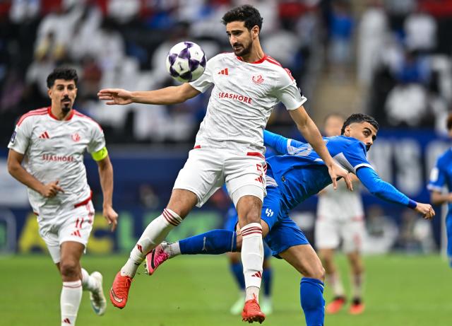 (261028) -- AL KHOR, Oct. 28, 2026 (Xinhua) -- Mohamed Romdhan (L) of Al Shamal SC vies with Ali Lajami of Al Hilal SFC during the AFC Champions League Elite football match between Qatar's Al Shamal SC and Saudi Arabia's Al Hilal SFC at Al Bayt Stadium, Al Khor, Qatar, Oct. 27, 2026. (Photo by Nikku/Xinhua)