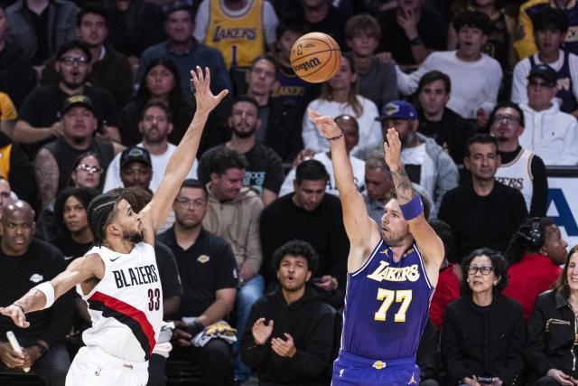(261028) -- LOS ANGELES, Oct. 28, 2026 (Xinhua) -- Luka Doncic (R) of Los Angeles Lakers shoots against Toumani Camara of Portland Trail Blazers during the NBA basketball game between Los Angeles Lakers and Portland Trail Blazers in Los Angeles, the United States, Oct. 27, 2026. (Photo by Ringo Chiu/Xinhua)