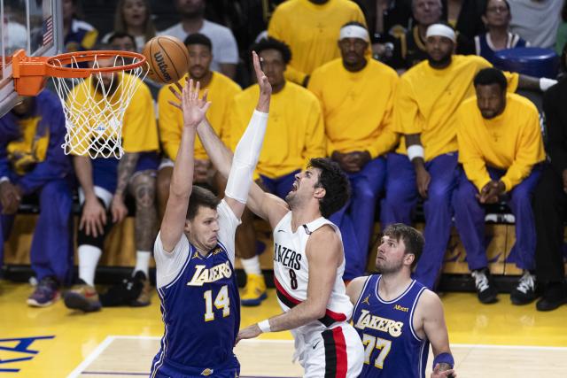 (261028) -- LOS ANGELES, Oct. 28, 2026 (Xinhua) -- Walker Kessler (L) of Los Angeles Lakers defends Deni Avdija (C) of Portland Trail Blazers during the NBA basketball game between Los Angeles Lakers and Portland Trail Blazers in Los Angeles, the United States, Oct. 27, 2026. (Photo by Ringo Chiu/Xinhua)