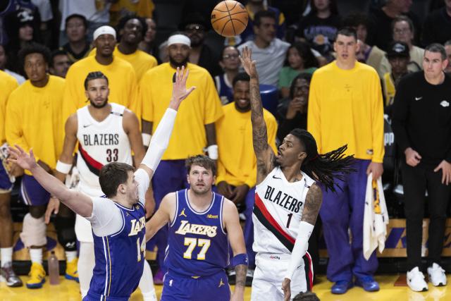 (261028) -- LOS ANGELES, Oct. 28, 2026 (Xinhua) -- Walker Kessler (front L) of Los Angeles Lakers defends Ja Morant of Portland Trail Blazers during the NBA basketball game between Los Angeles Lakers and Portland Trail Blazers in Los Angeles, the United States, Oct. 27, 2026. (Photo by Ringo Chiu/Xinhua)