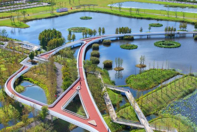 (261028) -- RUDONG, Oct. 28, 2026 (Xinhua) -- An aerial drone photo taken on Oct. 22, 2026 shows the Heming Park in Rudong County of Nantong City, east China's Jiangsu Province. In recent years, Rudong County in Nantong City has made efforts to improve its aquatic ecological environment. Water environment of the three rivers, namely the Taiyun River, the Jueju River and the Juekan River, which run through the county, has undergone sound remediation. Along these waterways, the Heming Park and the bank areas of tributaries have all formed a picturesque urban landscape for people to enjoy their leisure time. (Photo by Xu Congjun/Xinhua)