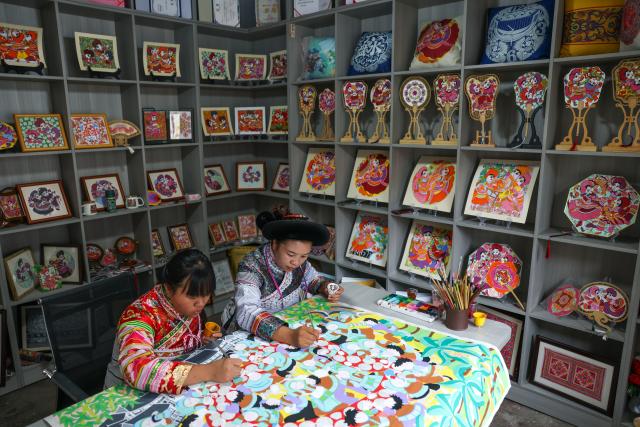(261028) -- LIUPANSHUI, Oct. 28, 2026 (Xinhua) -- Luo Banmei (R), a farmer painter, creates a painting with her daughter in Doujing Village of Shuicheng District in Liupanshui, southwest China's Guizhou Province, Oct. 5, 2026. In recent years, Shuicheng District has promoted its local art by offering painting training courses, establishing copyright trading platforms, and boosting the development of cultural and creative products.
   Shuicheng farmers' paintings are known for their bright, vibrant colors and exaggerated forms. These paintings bearing witness to local changes have become a cultural driver for rural revitalization. Since 2021, Shuicheng farmers' paintings have been exhibited in more than 20 countries and regions, including Britain, Japan and Australia. (Xinhua/Yang Wenbin)