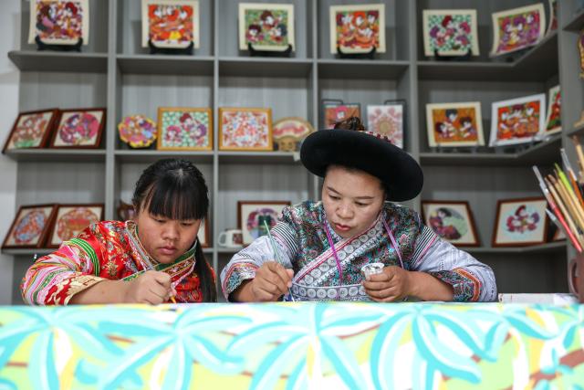 (261028) -- LIUPANSHUI, Oct. 28, 2026 (Xinhua) -- Luo Banmei (R), a farmer painter, creates a painting with her daughter in Doujing Village of Shuicheng District in Liupanshui, southwest China's Guizhou Province, Oct. 5, 2026. In recent years, Shuicheng District has promoted its local art by offering painting training courses, establishing copyright trading platforms, and boosting the development of cultural and creative products.
   Shuicheng farmers' paintings are known for their bright, vibrant colors and exaggerated forms. These paintings bearing witness to local changes have become a cultural driver for rural revitalization. Since 2021, Shuicheng farmers' paintings have been exhibited in more than 20 countries and regions, including Britain, Japan and Australia. (Xinhua/Yang Wenbin)