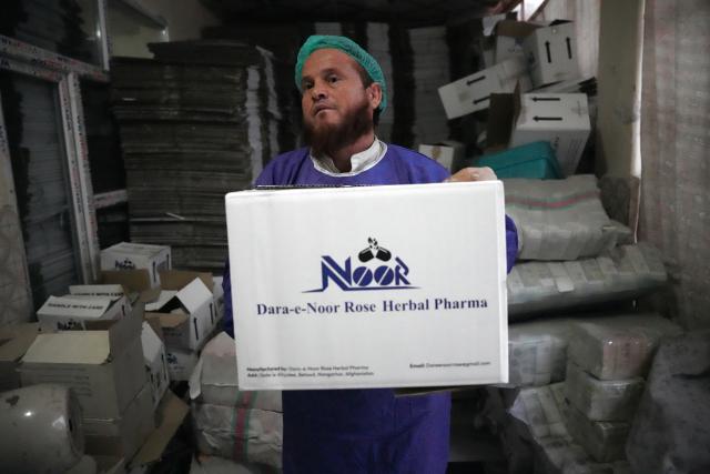 (261028) -- KABUL, Oct. 28, 2026 (Xinhua) -- An employee of Dara-e-Noor Rose Herbal Pharma carries products prepared for the 9th China International Import Expo (CIIE) in Jalalabad, Nangarhar Province, Afghanistan, Oct. 19, 2026. TO GO WITH "Feature: Afghan entrepreneurs look to China's annual import expo to unlock global markets" (Photo by Saifurahman Safi/Xinhua)