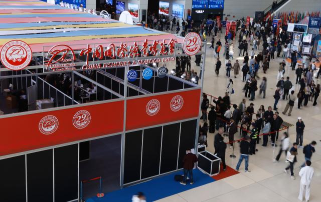 (261028) -- QINGDAO, Oct. 28, 2026 (Xinhua) -- People visit the 29th China Fisheries & Seafood Expo in Qingdao, east China's Shandong Province, Oct. 28, 2026. The expo kicked off here on Wednesday, with an exhibition area of approximately 120,000 square meters, showcasing exhibits covering aquatic raw materials and processed products, aquaculture and processing technologies and equipment, and cold chain logistics facilities. The expo, which will last until Oct. 30, has attracted numerous domestic and international manufacturers and buyers to seek business opportunities. (Xinhua/Gao Jing)
