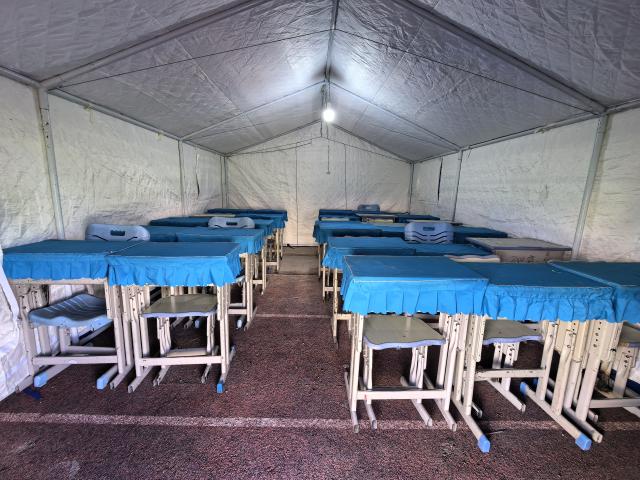 (261028) -- XINING, Oct. 28, 2026 (Xinhua) -- This photo taken on Oct. 24, 2026 shows a makeshift classroom in tent on the playground of Jieduo Township Central Boarding School in Jieduo of Yushu Tibetan Autonomous Prefecture, northwest China's Qinghai Province. TO GO WITH "Feature: Sixteen years of drills to secure three minutes to safety at rural Chinese school" (Xinhua)