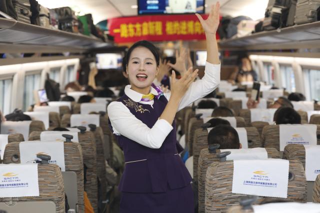 (261028) -- SHANGHAI, Oct. 28, 2026 (Xinhua) -- Staff members perform for passengers during an activity promoting the upcoming 9th China International Import Expo (CIIE) on the train G901, Oct. 28, 2026. A promotion activity was held on the train G901 on Wednesday to show highlights of this year's CIIE, which will be held in Shanghai from Nov. 5 to 10. (Xinhua/Wang Xiang)
