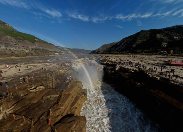 (261028) -- JIXIAN, Oct. 28, 2026 (Xinhua) -- An aerial drone photo taken in Jixian County, north China's Shanxi Province, on Oct. 28, 2026, shows a rainbow over the Yellow River's Hukou Waterfall. (Photo by Lyu Guiming/Xinhua)