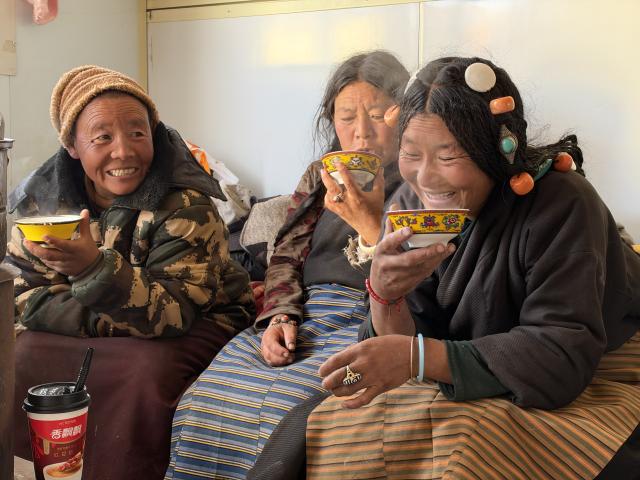(261028) -- BAQEN, Oct. 28, 2026 (Xinhua) -- Villagers enjoy butter tea in a prefabricated house at a resettlement site of a quake-hit village in Maru Township of Baqen County, Nagqu City, southwest China's Xizang Autonomous Region, on Oct. 28, 2026. A 7.0-magnitude earthquake had struck Baqen County in southwest China's Xizang Autonomous Region on Oct. 22. Days after the quake, villagers from Baqen County have started moving into prefabricated houses which rescue workers had rushed against the clock to build in the wake of the quake, and steadily restored their life order. (Photo by Chen Xiaojun/Xinhua)