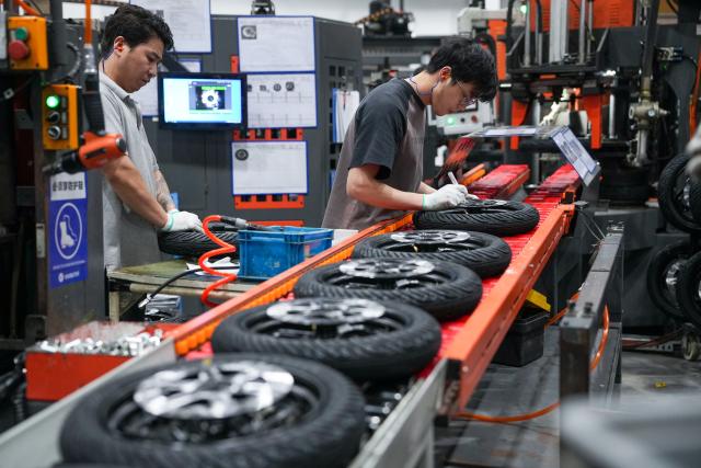 (261028) -- NANJING, Oct. 28, 2026 (Xinhua) -- Workers operate at a tire assembly line at a smart electric two-wheeler company in Changzhou, east China's Jiangsu Province, Oct. 14, 2026.
  In recent years, Changzhou City has leveraged its traditional strengths in manufacturing to accelerate the clustering of electric two-wheeler manufacturers and their component suppliers, aiming at development of more smart and high-end products. 
  The city now accounts for about 10 percent of China's output of electric two-wheelers and has established a complete industrial chain spanning from parts to general assembly. 
  Changzhou has also actively reinforced the technological innovation as the main driver of the industry, as local makers keep boosting R&D efforts to further improve their products. (Xinhua/Li Bo)
