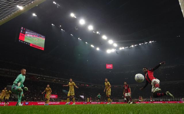 (261029) -- MILAN, Oct. 29, 2026 (Xinhua) -- AC Milan's Alphadjo Cisse (1st R) shoots to score during a Serie A football match between AC Milan and Bologna in Milan, Italy, Oct. 28, 2026. (Photo by Alberto Lingria/Xinhua)