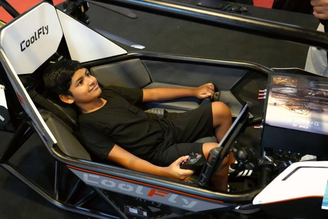 (261029) -- MALE, Oct. 29, 2026 (Xinhua) -- A teenager tries out a Chinese manned aerial vehicle at Maldives Expo 2026, in Male, Maldives, Oct. 27, 2026. The expo attracted approximately 430 exhibitors, showcasing more than 4,400 exhibits across seven themed exhibition zones. Twelve Chinese enterprises participated in the event, bringing new opportunities for Maldivian SMEs to enhance operational efficiency and expand international cooperation. (Xinhua/Xu Han)