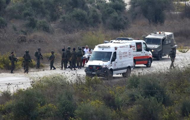 (261029) -- NABLUS, Oct. 29, 2026 (Xinhua) -- Israeli military forces are seen gathering around an injured Palestinian man near the Huwara checkpoint, south of the West Bank city of Nablus, Oct. 27, 2026. The Israeli military forces shot a Palestinian young man in the foot. The injured man was handed over to Red Crescent crews for transfer to hospital for treatment. (Photo by Nidal Eshtayeh/Xinhua)