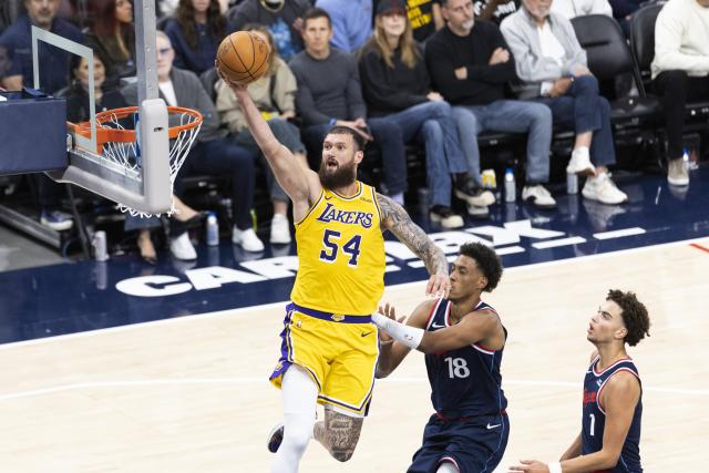 (261029) -- LOS ANGELES, Oct. 29, 2026 (Xinhua) -- Sandro Mamukelashvili (L) of Los Angeles Lakers goes for a lay up during the NBA basketball game between Los Angeles Lakers and Los Angeles Clippers in Los Angeles, the United States, Oct. 28, 2026. (Photo by Ringo Chiu/Xinhua)