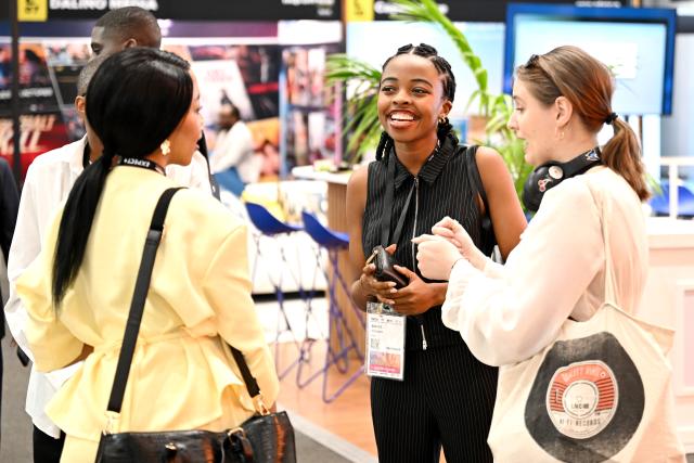 (261029) -- CAPE TOWN, Oct. 29, 2026 (Xinhua) -- People communicate at a trade exhibition at MIP Africa 2026 in Cape Town, South Africa, Oct. 28, 2026. The China Pavilion took center stage on Wednesday at MIP Africa 2026, a major film and television industry event in Africa, featuring a diverse range of Chinese audiovisual content, promoting cultural exchange and industry cooperation between China and the continent.
   TO GO WITH "Roundup: China Pavilion takes center stage at major African audiovisual event" (Photo by Xabiso Mkhabela/Xinhua)