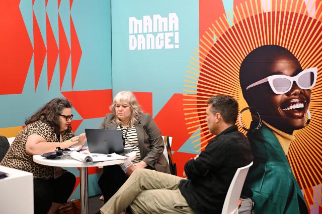 (261029) -- CAPE TOWN, Oct. 29, 2026 (Xinhua) -- People communicate at a trade exhibition at MIP Africa 2026 in Cape Town, South Africa, Oct. 28, 2026. The China Pavilion took center stage on Wednesday at MIP Africa 2026, a major film and television industry event in Africa, featuring a diverse range of Chinese audiovisual content, promoting cultural exchange and industry cooperation between China and the continent.
   TO GO WITH "Roundup: China Pavilion takes center stage at major African audiovisual event" (Photo by Xabiso Mkhabela/Xinhua)
