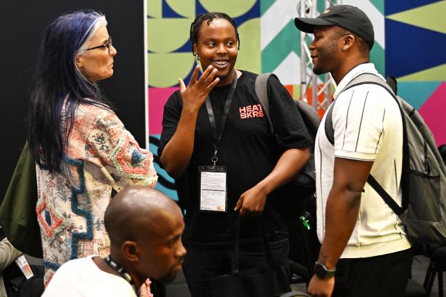 (261029) -- CAPE TOWN, Oct. 29, 2026 (Xinhua) -- People communicate at a trade exhibition at MIP Africa 2026 in Cape Town, South Africa, Oct. 28, 2026. The China Pavilion took center stage on Wednesday at MIP Africa 2026, a major film and television industry event in Africa, featuring a diverse range of Chinese audiovisual content, promoting cultural exchange and industry cooperation between China and the continent.
   TO GO WITH "Roundup: China Pavilion takes center stage at major African audiovisual event" (Photo by Xabiso Mkhabela/Xinhua)