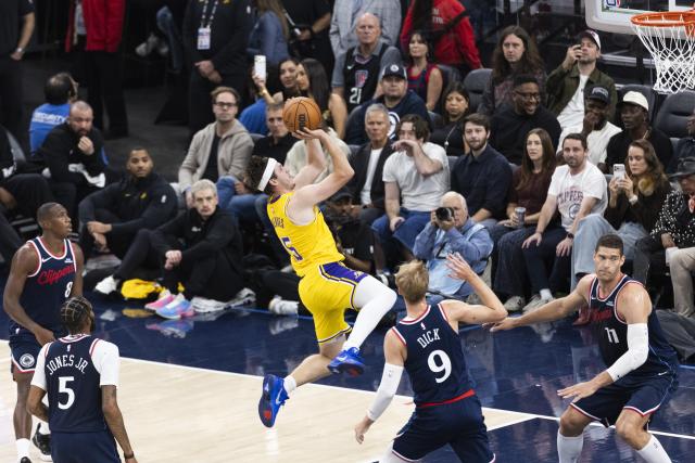 (261029) -- LOS ANGELES, Oct. 29, 2026 (Xinhua) -- Austin Reaves (top) of Los Angeles Lakers jumps to shoot during the NBA basketball game between Los Angeles Lakers and Los Angeles Clippers in Los Angeles, the United States, Oct. 28, 2026. (Photo by Ringo Chiu/Xinhua)