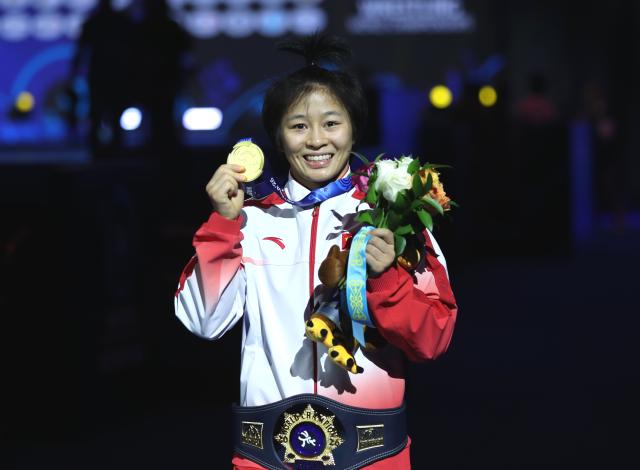 (261029) -- ASTANA, Oct. 29, 2026 (Xinhua) -- Winner Hong Kexin of China poses during the awarding ceremony for the women's wrestling 57kg event at the 2026 Senior World Championships in Astana, Kazakhstan, Oct. 28, 2026. (Photo by Kalizhan Ospanov/Xinhua)