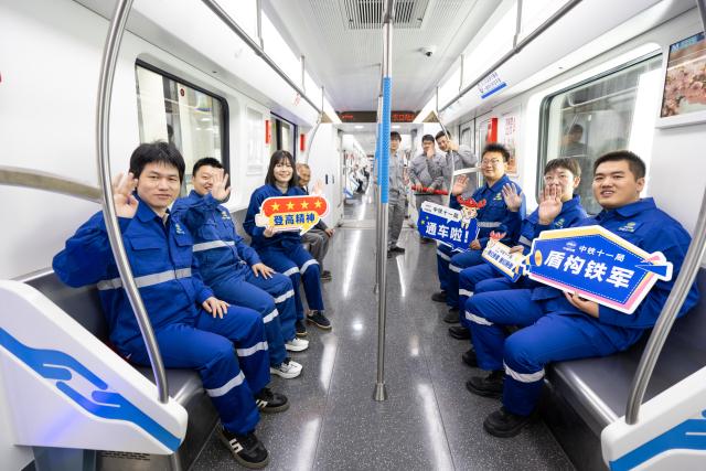 (261029) -- WUHAN, Oct. 29, 2026 (Xinhua) -- Constructors take a train of the Wuhan Metro Line 12 in Wuhan, central China's Hubei Province, Oct. 29, 2026.
  China's longest subway loop line, the Wuhan Metro Line 12, started full line operation on Thursday. The 59.9-km line has 37 stations and stretches across seven administrative districts of the city. 
  By far, the total mileage of Wuhan Metro in operation has exceeded 581 kilometers. (Xinhua/Xiao Yijiu)