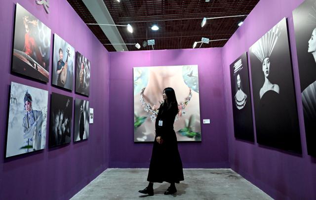 (261029) -- SANMENXIA, Oct. 29, 2026 (Xinhua) -- A visitor views photo works at an exhibition during the 16th China Photography Festival in Sanmenxia City, central China's Henan Province, Oct. 29, 2026. The 16th China Photography Festival kicked off here on Thursday, featuring exhibitions covering a variety of themes, including documentary and art. (Xinhua/Zhu Xiang)
