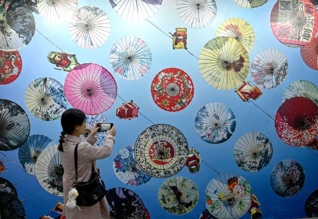 (261029) -- SANMENXIA, Oct. 29, 2026 (Xinhua) -- A visitor takes photos at an exhibition during the 16th China Photography Festival in Sanmenxia City, central China's Henan Province, Oct. 29, 2026. The 16th China Photography Festival kicked off here on Thursday, featuring exhibitions covering a variety of themes, including documentary and art. (Xinhua/Zhu Xiang)