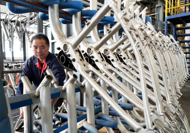 (261029) -- TANGSHAN, Oct. 29, 2026 (Xinhua) -- A staff member operates at the workshop of a bicycle component manufacturing enterprise in Lutai economic development zone of Tangshan City, north China's Hebei Province, Oct. 28, 2026. In recent years, Lutai economic development zone in Tangshan City has continuously promoted the upgrading of its bicycle industry. Local manufacturers are encouraged to expand their operation from mere production of components to development and production of ready-for-use bicycles. There are 55 of such manufacturers in this district, covering production of bicycles, bicycle parts, and motors for electric two-wheelers. (Xinhua/Yang Shiyao)