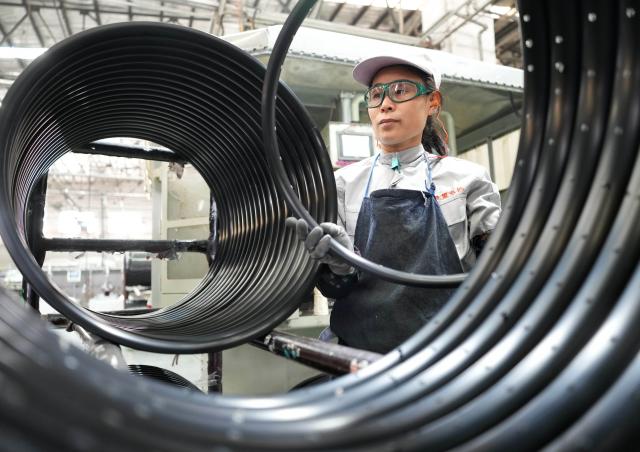 (261029) -- TANGSHAN, Oct. 29, 2026 (Xinhua) -- A staff member operates at the workshop of a bicycle component manufacturing enterprise in Lutai economic development zone of Tangshan City, north China's Hebei Province, Oct. 28, 2026. In recent years, Lutai economic development zone in Tangshan City has continuously promoted the upgrading of its bicycle industry. Local manufacturers are encouraged to expand their operation from mere production of components to development and production of ready-for-use bicycles. There are 55 of such manufacturers in this district, covering production of bicycles, bicycle parts, and motors for electric two-wheelers. (Xinhua/Yang Shiyao)