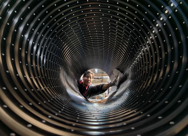 (261029) -- TANGSHAN, Oct. 29, 2026 (Xinhua) -- A staff member operates at the workshop of a bicycle component manufacturing enterprise in Lutai economic development zone of Tangshan City, north China's Hebei Province, Oct. 28, 2026. In recent years, Lutai economic development zone in Tangshan City has continuously promoted the upgrading of its bicycle industry. Local manufacturers are encouraged to expand their operation from mere production of components to development and production of ready-for-use bicycles. There are 55 of such manufacturers in this district, covering production of bicycles, bicycle parts, and motors for electric two-wheelers. (Xinhua/Yang Shiyao)