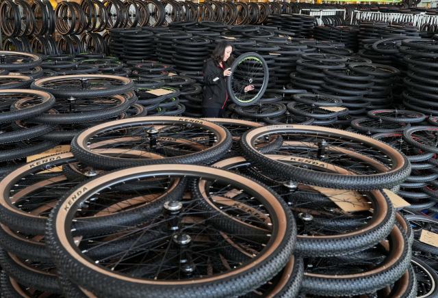 (261029) -- TANGSHAN, Oct. 29, 2026 (Xinhua) -- A staff member operates at the workshop of a bicycle enterprise in Lutai economic development zone of Tangshan City, north China's Hebei Province, Oct. 28, 2026. In recent years, Lutai economic development zone in Tangshan City has continuously promoted the upgrading of its bicycle industry. Local manufacturers are encouraged to expand their operation from mere production of components to development and production of ready-for-use bicycles. There are 55 of such manufacturers in this district, covering production of bicycles, bicycle parts, and motors for electric two-wheelers. (Xinhua/Yang Shiyao)