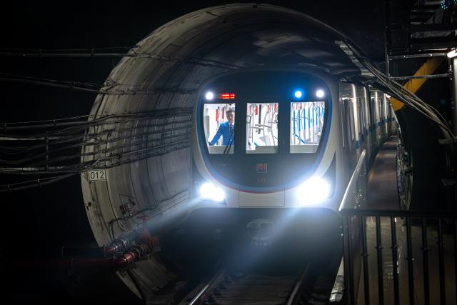 (261030) -- BEIJING, Oct. 30, 2026 (Xinhua) -- A train of the Wuhan Metro Line 12 arrives at a station in Wuhan, central China's Hubei Province, Oct. 29, 2026.
  China's longest subway loop line, the Wuhan Metro Line 12, started full line operation on Thursday. The 59.9-km line has 37 stations and stretches across seven administrative districts of the city. By far, the total mileage of Wuhan Metro in operation has exceeded 581 kilometers. (Xinhua/Xiao Yijiu)