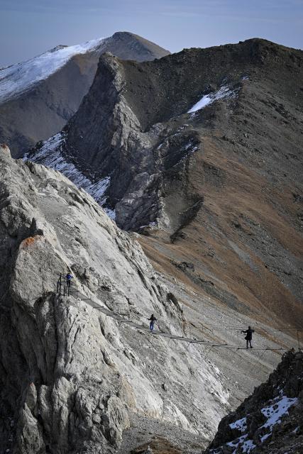 (261030) -- CHERKESSK, Oct. 30, 2026 (Xinhua) -- Tourists experience a suspension bridge in the Arkhyz resort area in the Karachay-Cherkessia Republic, Russia, Oct. 29, 2026. Arkhyz is a mountain village and a well-known tourist resort at the foot of the Greater Caucasus Mountains in the Karachay-Cherkessia Republic in southern Russia. (Xinhua/Feng Kaihua)