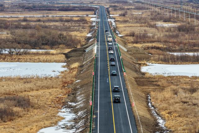(261030) -- FUYUAN, Oct. 30, 2026 (Xinhua) -- An aerial drone photo shows vehicles going on a trial driving on the road leading to the Heixiazi Island Road Port, Oct. 30, 2026. A completion ceremony for the construction of the Heixiazi Island Road Passenger Port was held in Fuyuan City on Friday. 
  The Heixiazi Island Road Port will provide efficient round-the-clock customs clearance, effectively easing the clearance pressure on the Fuyuan Port, and deepening economic and trade cooperation and cultural exchanges between China and Russia. (Xinhua/Zhang Tao)