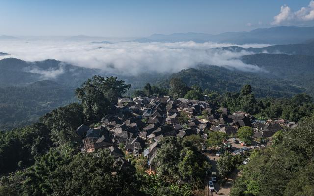 (261030) -- PU'ER, Oct. 30, 2026 (Xinhua) -- An aerial drone photo taken on Oct. 30, 2026 shows a view of Wengji Village nestled in Jingmai Mountain, in Lancang Lahu Autonomous County of Pu'er City, southwest China's Yunnan Province. (Xinhua/Wang Guansen)