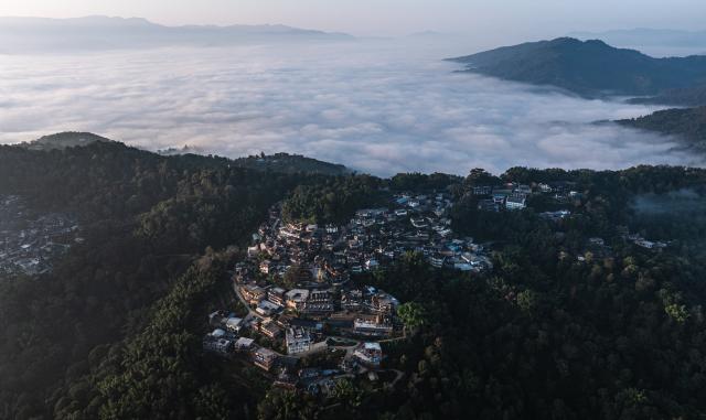 (261030) -- PU'ER, Oct. 30, 2026 (Xinhua) -- An aerial drone photo taken on Oct. 30, 2026 shows a view of a village nestled in Jingmai Mountain, in Lancang Lahu Autonomous County of Pu'er City, southwest China's Yunnan Province. (Xinhua/Wang Guansen)