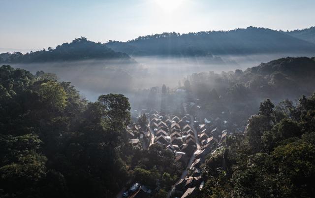 (261030) -- PU'ER, Oct. 30, 2026 (Xinhua) -- An aerial drone photo taken on Oct. 30, 2026 shows a view of Nuogan Village nestled in Jingmai Mountain, in Lancang Lahu Autonomous County of Pu'er City, southwest China's Yunnan Province. (Xinhua/Wang Guansen)