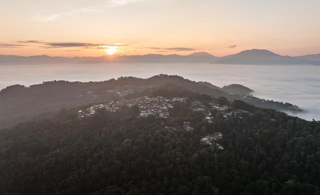 (261030) -- PU'ER, Oct. 30, 2026 (Xinhua) -- An aerial drone photo taken on Oct. 30, 2026 shows a view of a village nestled in Jingmai Mountain, in Lancang Lahu Autonomous County of Pu'er City, southwest China's Yunnan Province. (Xinhua/Wang Guansen)