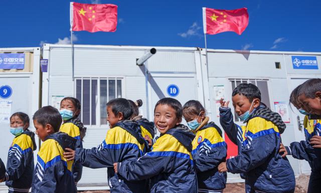 (261030) -- BAQEN, Oct. 30, 2026 (Xinhua) -- Children walk to a makeshift kindergarten at a resettlement site of a quake-hit village in Maru Township of Baqen County, Nagqu City, southwest China's Xizang Autonomous Region, on Oct. 30, 2026. A makeshift kindergarten opened recently at a resettlement site here. Inside the comprehensively disinfected and carefully decorated facility, teachers are helping children from quake-hit villages adapt as soon as possible to learning and daily life at the resettlement site. (Xinhua/Tenzin Nyida)