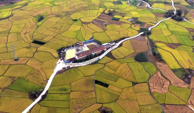 (261030) -- LIUZHOU, Oct. 30, 2026 (Xinhua) -- An aerial drone photo taken on Oct. 30, 2026 shows the rural autumn scenery in Xingui Village of Rong'an County, Liuzhou City, south China's Guangxi Zhuang Autonomous Region. Currently, late rice in Rong'an County is entering its harvest season. The rural fields are dyed in autumn colors. (Xinhua/Huang Xiaobang)