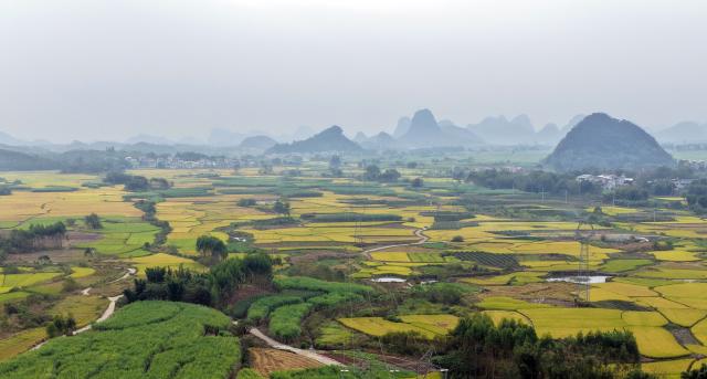 (261030) -- LIUZHOU, Oct. 30, 2026 (Xinhua) -- An aerial drone photo taken on Oct. 30, 2026 shows the rural autumn scenery in Xingui Village of Rong'an County, Liuzhou City, south China's Guangxi Zhuang Autonomous Region. Currently, late rice in Rong'an County is entering its harvest season. The rural fields are dyed in autumn colors. (Xinhua/Huang Xiaobang)