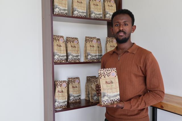 (261030) -- ADDIS ABABA, Oct. 30, 2026 (Xinhua) -- Kaleab Fekad, marketing manager of AWO Coffee, presents a bag of coffee product at a coffee shop in Addis Ababa, Ethiopia on Oct. 24, 2026. As the 9th China International Import Expo (CIIE) approaches, executives of Ethiopian coffee company AWO Coffee are making final preparations for the event, seeking to tap the potential of China's fast-growing coffee market.
   TO GO WITH "Feature: Ethiopian coffee firm eyes greater opportunities in China through CIIE" (Xinhua/Liu Fangqiang)