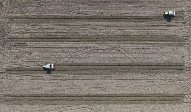 (261030) -- DONGYUAN, Oct. 30, 2026 (Xinhua) -- A drone photo taken on Oct. 30, 2026 shows unmanned agricultural machines plowing the field along preset routes on an intelligent farm in Liucheng Town of Dongyuan County, south China's Guangdong Province.
  A group of unmanned agricultural machinery developed by a Chinese research team from the country's South China Agricultural University conducted live field demonstrations here on Friday, showcasing a new model for modern smart agriculture. (Xinhua/Deng Hua)